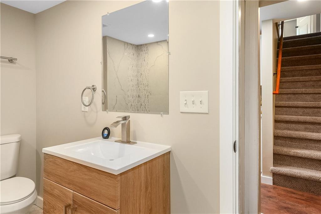 117 Fountain Street Pittsburgh, PA 15212 - Photo 8 of 21 First floor bathroom vanity, mirror, and toilet.