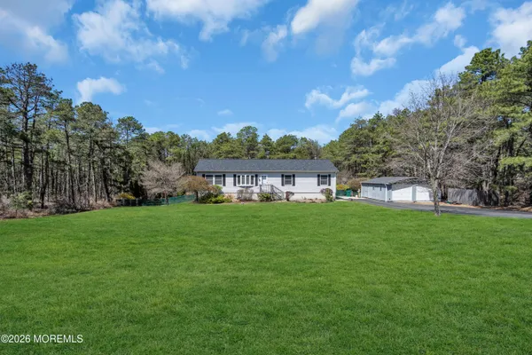 a view of a big yard with a house in the background