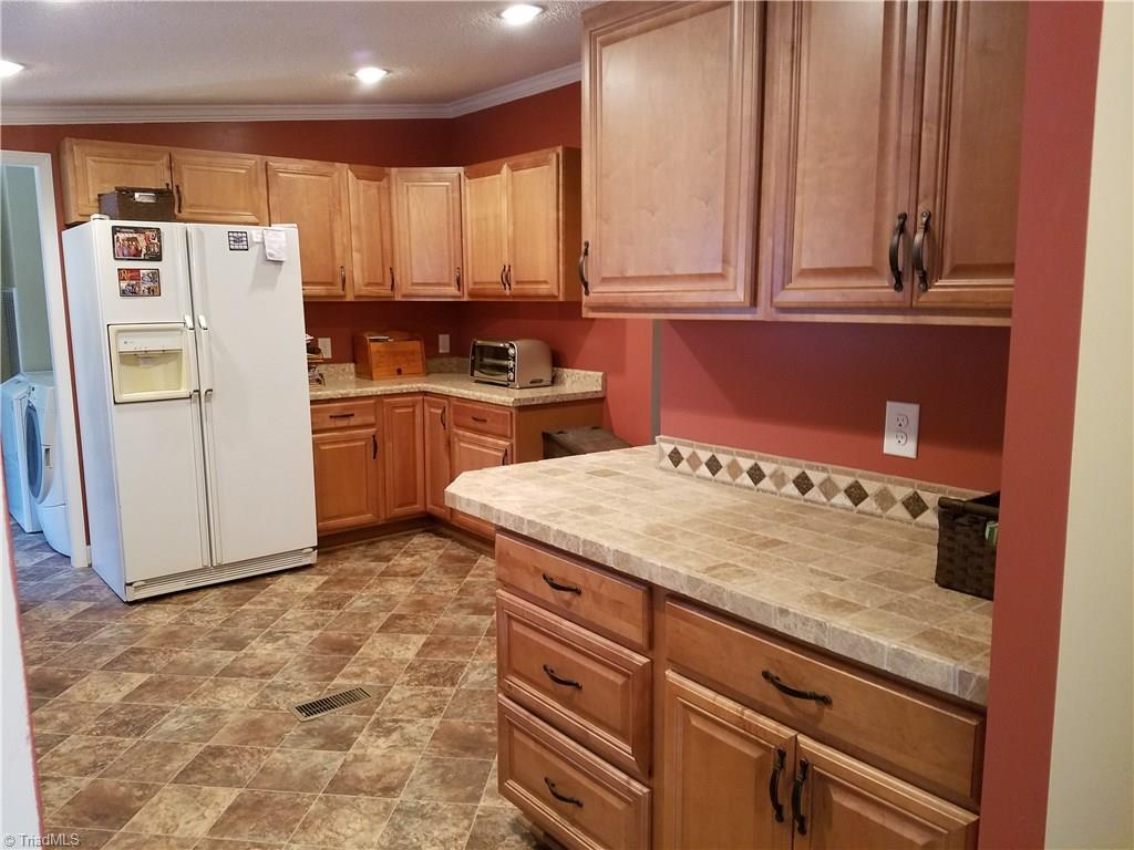 344 Prison Camp Road Dobson, NC 27017 - Photo 14 of 28 LOTS OF NEW RESIDENTIAL CABINETS- BAR AREA WITH TILE COUNTER TOP