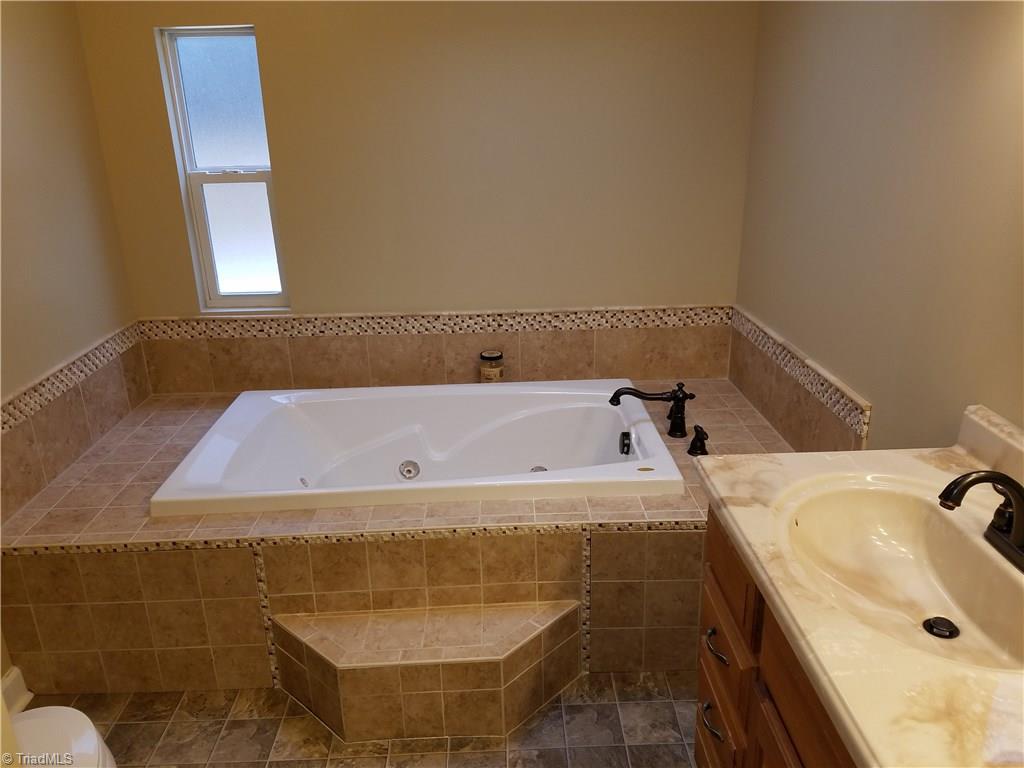 344 Prison Camp Road Dobson, NC 27017 - Photo 22 of 28 NEW RESIDENTIAL JACUZZI TUB AND VANITY WITH SOAP STONE TILE.