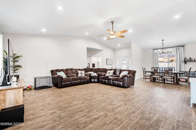 a open kitchen with stainless steel appliances granite countertop a refrigerator and a stove top oven