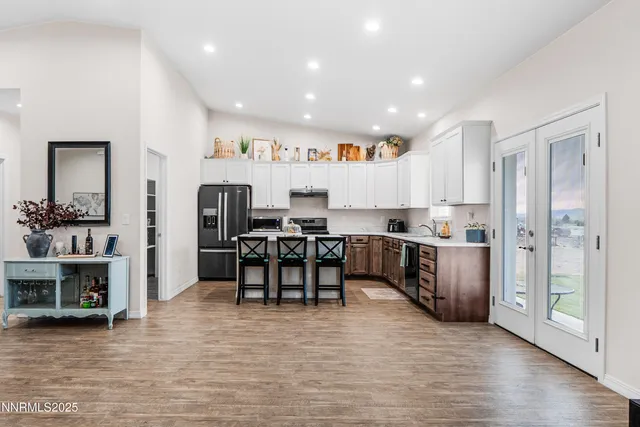 a kitchen with refrigerator and cabinets