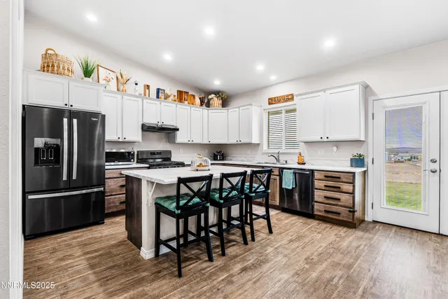 a kitchen with a sink a stove and cabinets