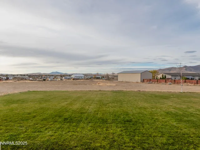 a view of a lake with houses in the back