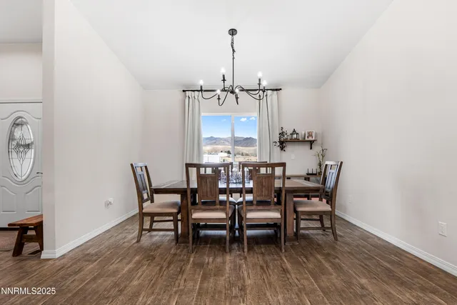 a living room with furniture kitchen view and a chandelier