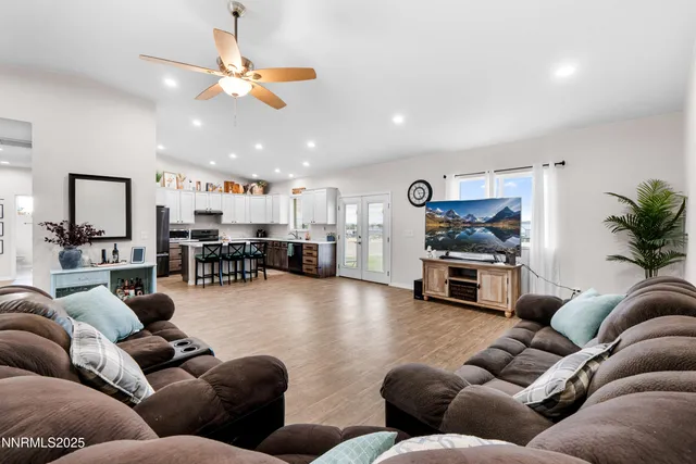 a living room with furniture and kitchen view