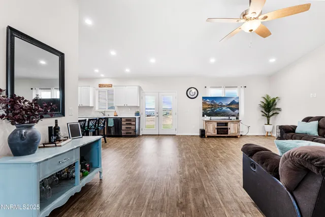 a living room with furniture a ceiling fan and a rug