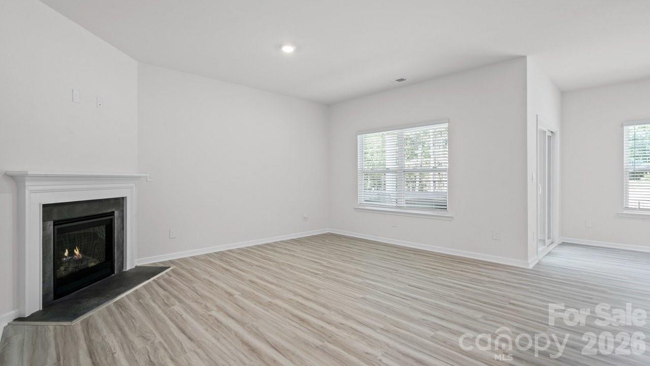 3688 Mercer Street Terrell, NC 28682 - Photo 18 of 34 a view of an empty room with wooden floor fireplace and a window