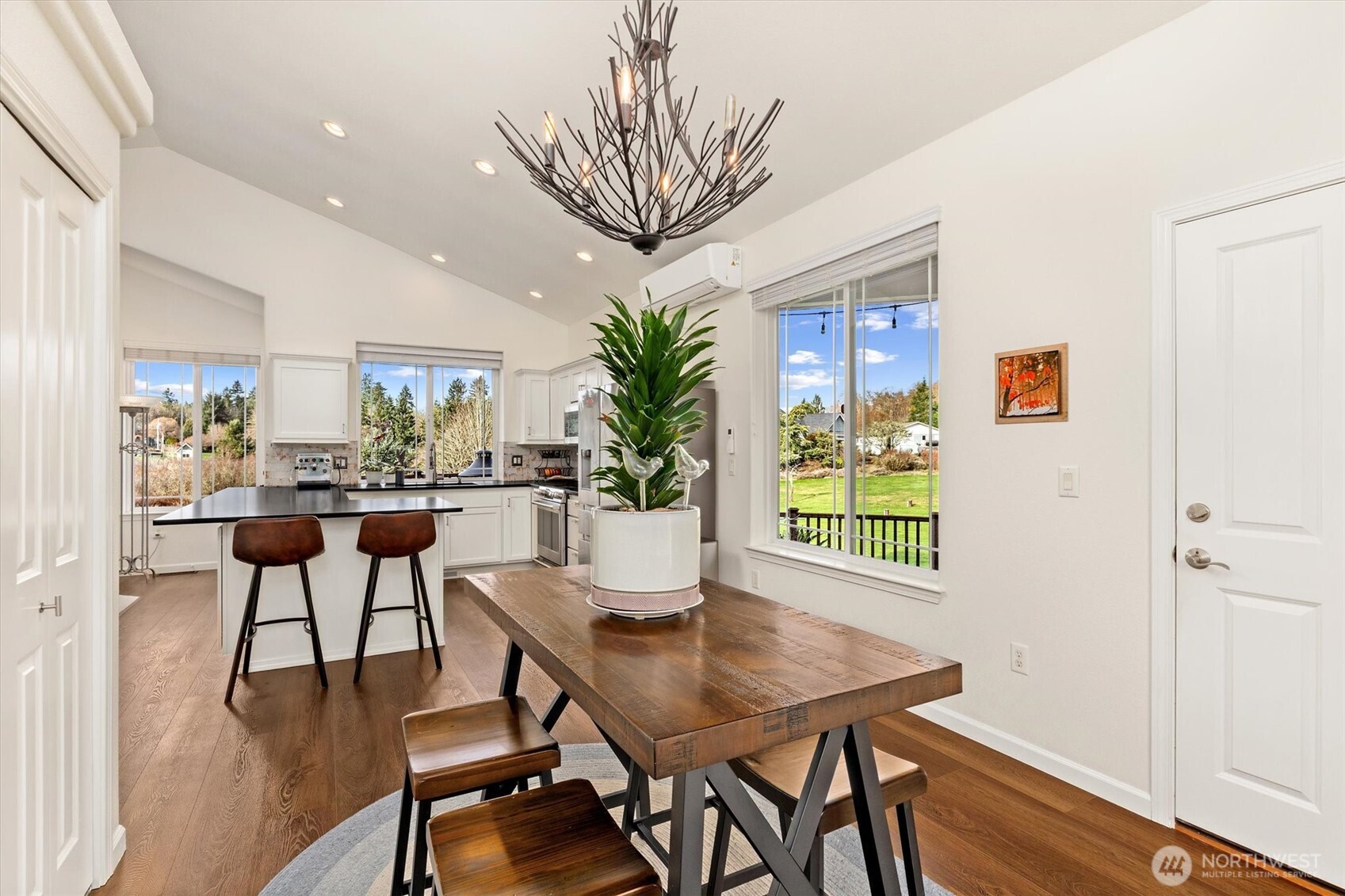 4946 Pleasant Glade Road Northeast Olympia, WA 98516 - Photo 12 of 38 a view of a dining room with furniture window and wooden floor