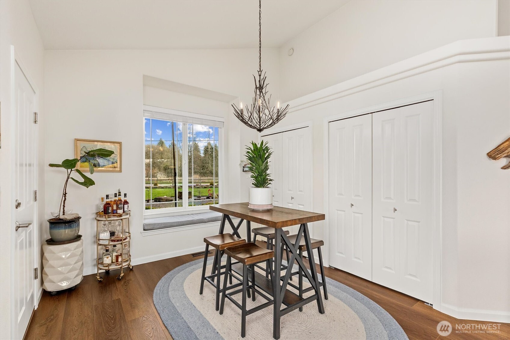 4946 Pleasant Glade Road Northeast Olympia, WA 98516 - Photo 13 of 38 a view of a dining room with furniture window and wooden floor