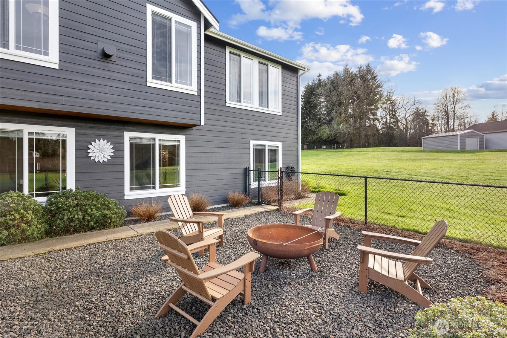 4946 Pleasant Glade Road Northeast Olympia, WA 98516 - Photo 32 of 38 a view of a patio with table and chairs with wooden fence and plants