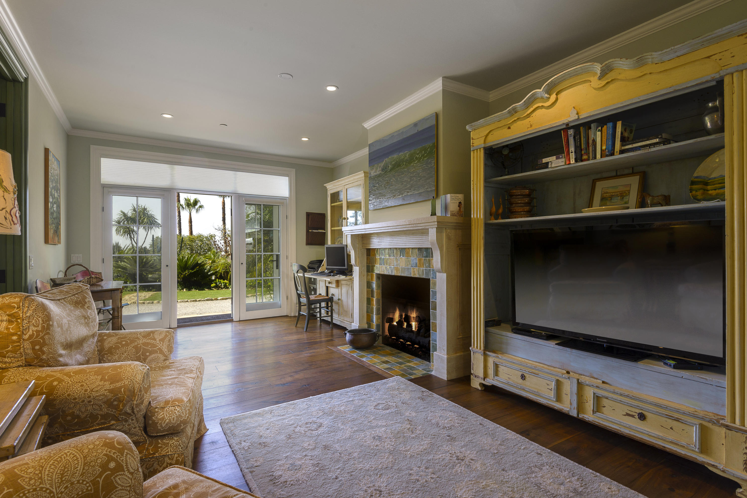 495 Toro Canyon Road Santa Barbara, CA 93108 - Photo 11 of 17 a living room with furniture flat screen tv and a fireplace