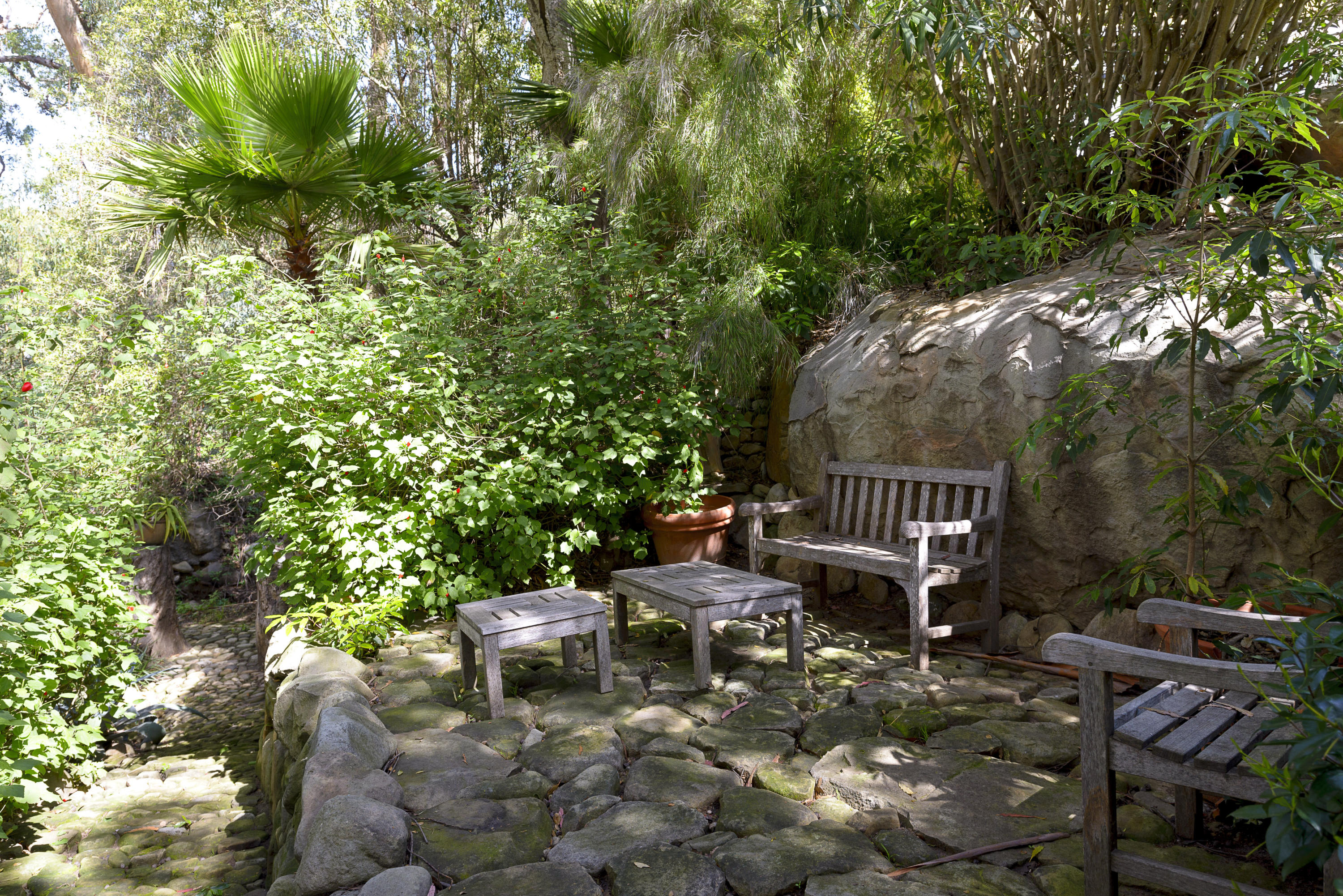 495 Toro Canyon Road Santa Barbara, CA 93108 - Photo 15 of 17 a view of a chair and tables in the backyard