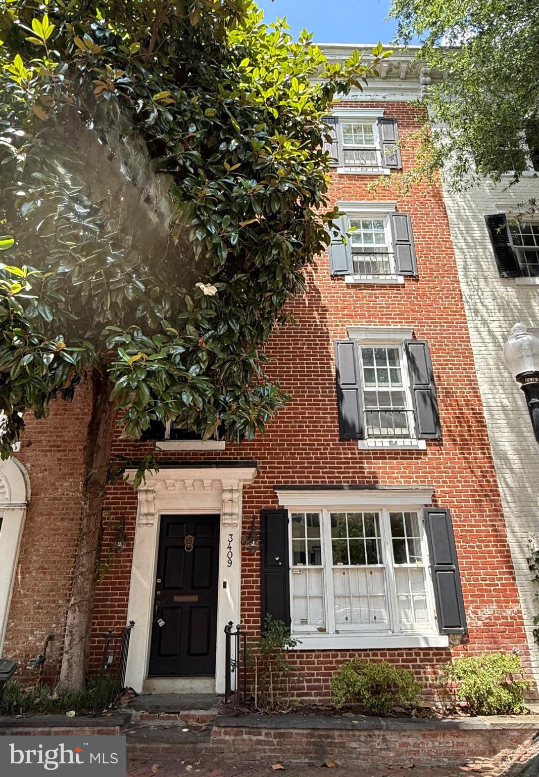 Charming brick facade with classic shutters.