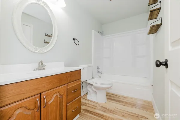 a bathroom with a sink a toilet and a mirror