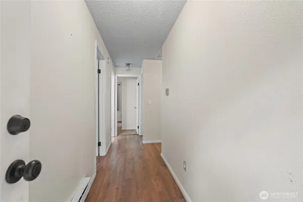 a view of a hallway with wooden floor