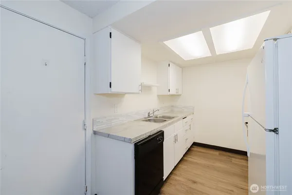a kitchen with a sink stove and cabinets