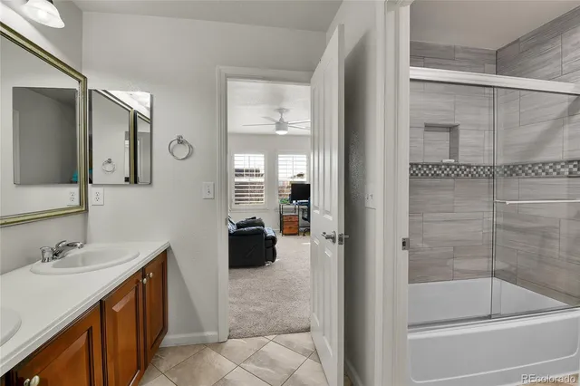 a bathroom with a tub sink and mirror