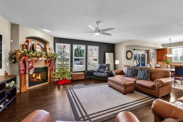a living room with furniture fireplace and a window