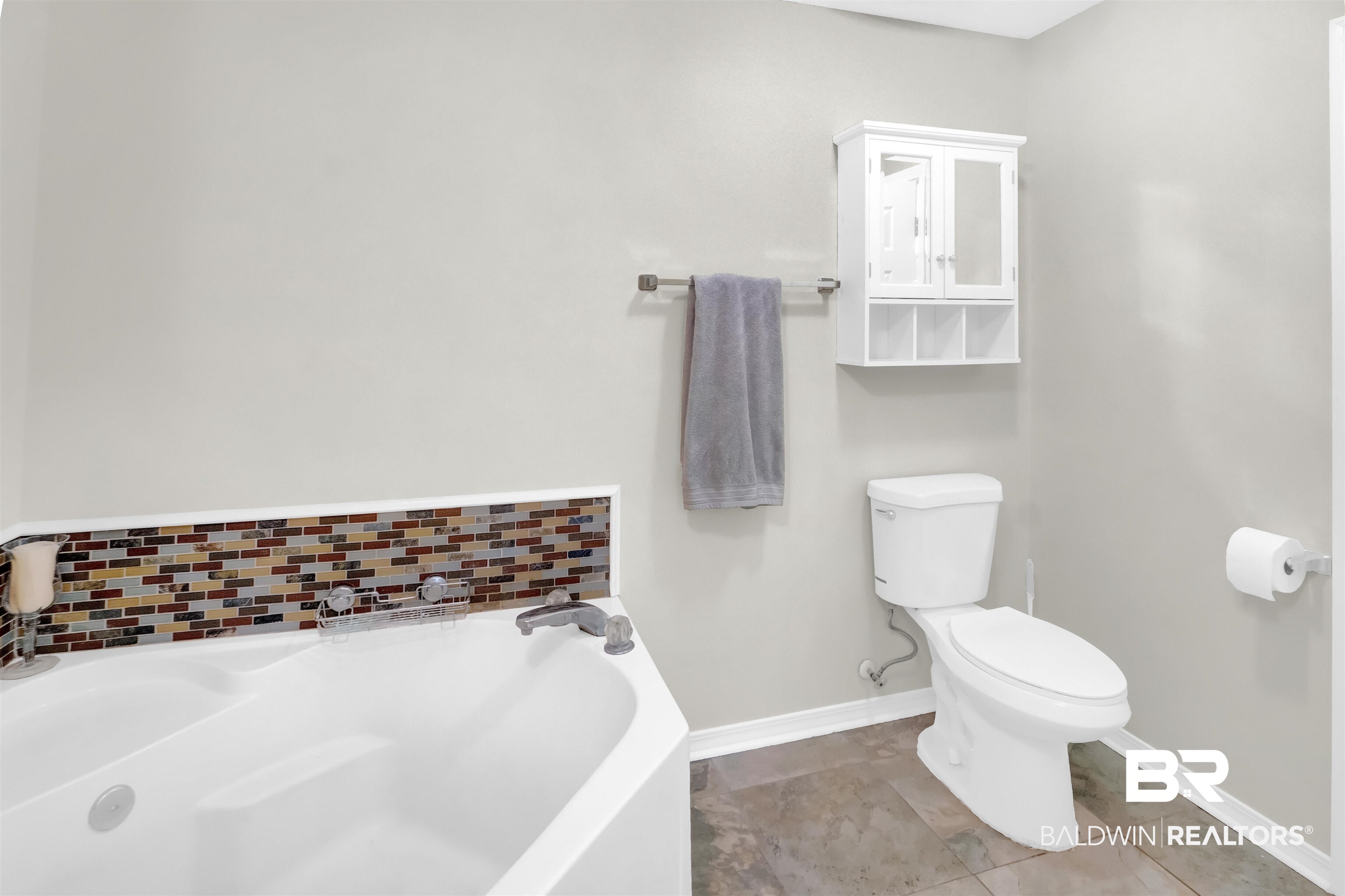30871 Stanton Road Spanish Fort, AL 36527 - Photo 31 of 35 Bathroom featuring toilet, a tub to relax in, and tile patterned flooring