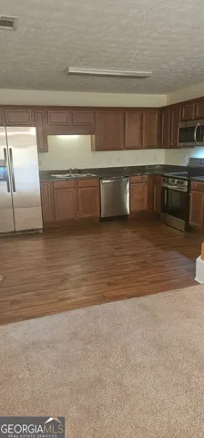 a view of kitchen and empty room