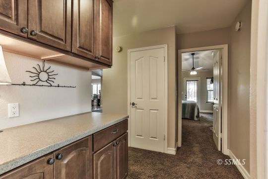 1220 Jennifer Court Ridgecrest, CA 93555 - Photo 20 of 34 a kitchen with a refrigerator and cabinets