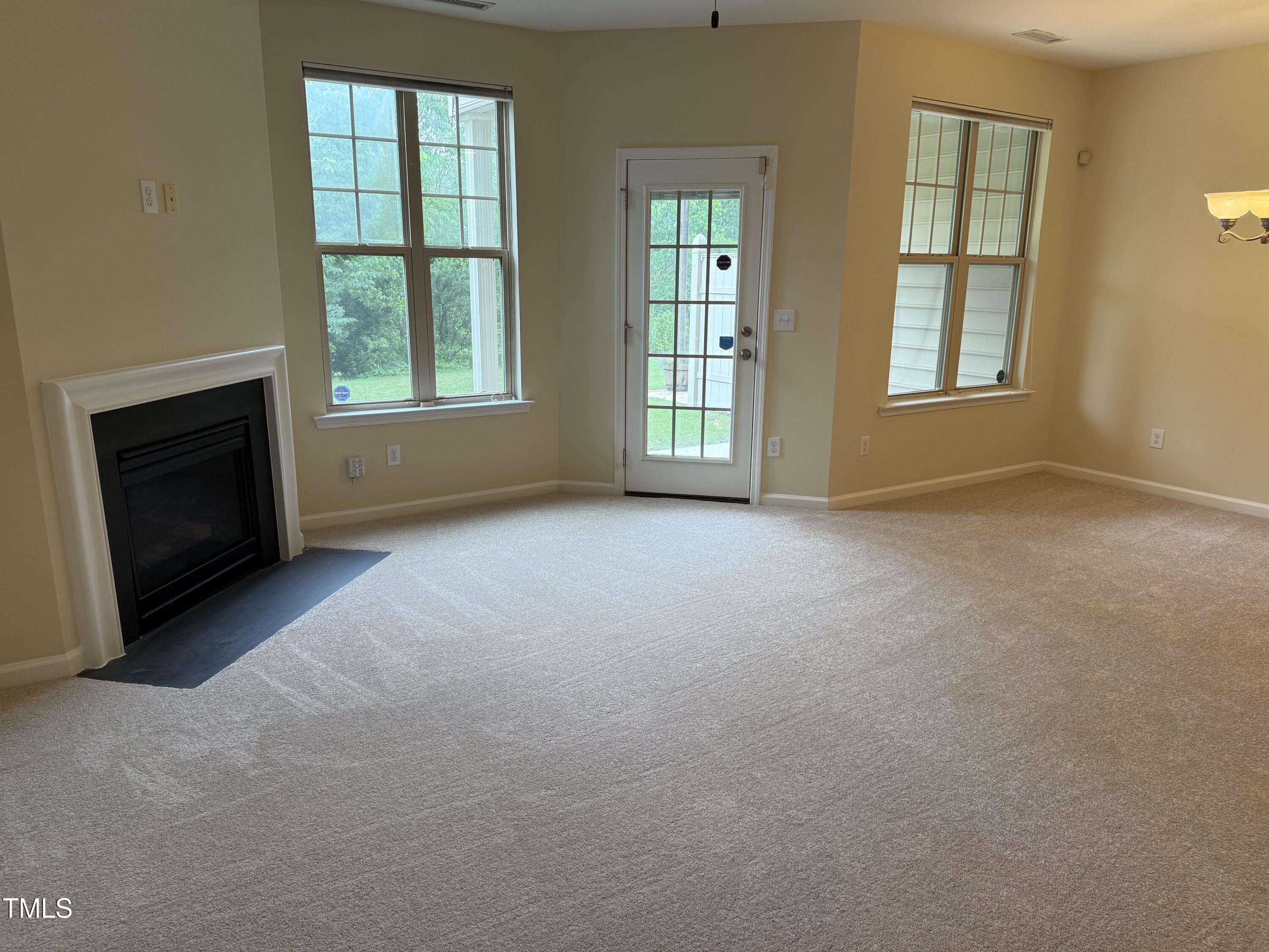 8254 Primanti Boulevard Raleigh, NC 27612 - Photo 11 of 39 Warm Fireplace with large living room