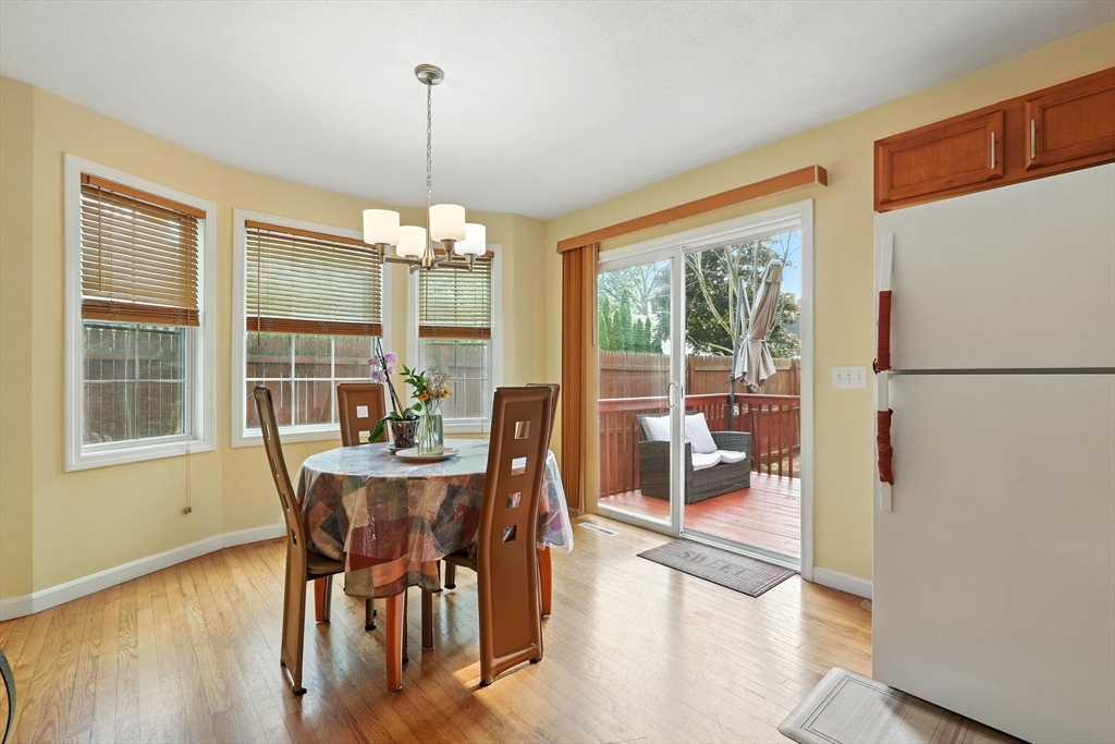 82 Lloyd Avenue Springfield, MA 01119 - Photo 13 of 32 a dining room with furniture a chandelier and wooden floor