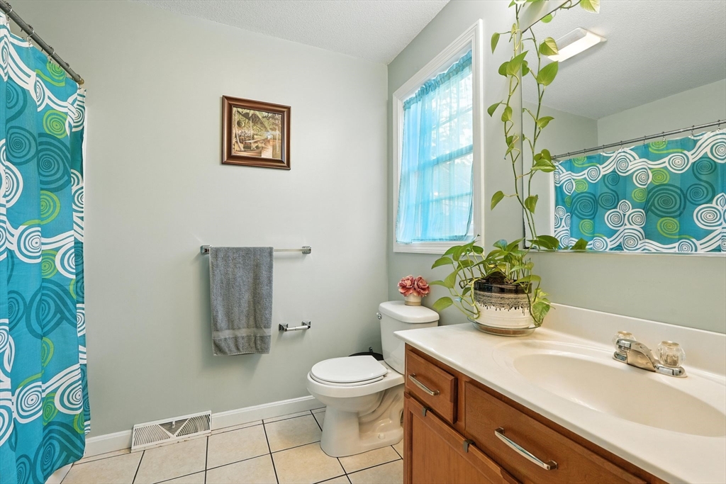 82 Lloyd Avenue Springfield, MA 01119 - Photo 15 of 32 a bathroom with a toilet sink and mirror