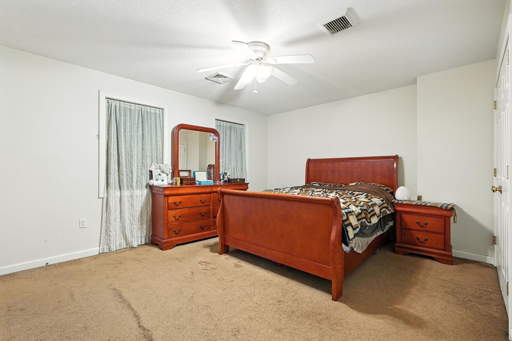 82 Lloyd Avenue Springfield, MA 01119 - Photo 16 of 32 a bed room with a bed and a dresser