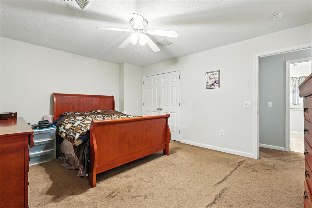 82 Lloyd Avenue Springfield, MA 01119 - Photo 17 of 32 a bedroom with a bed and a chandelier