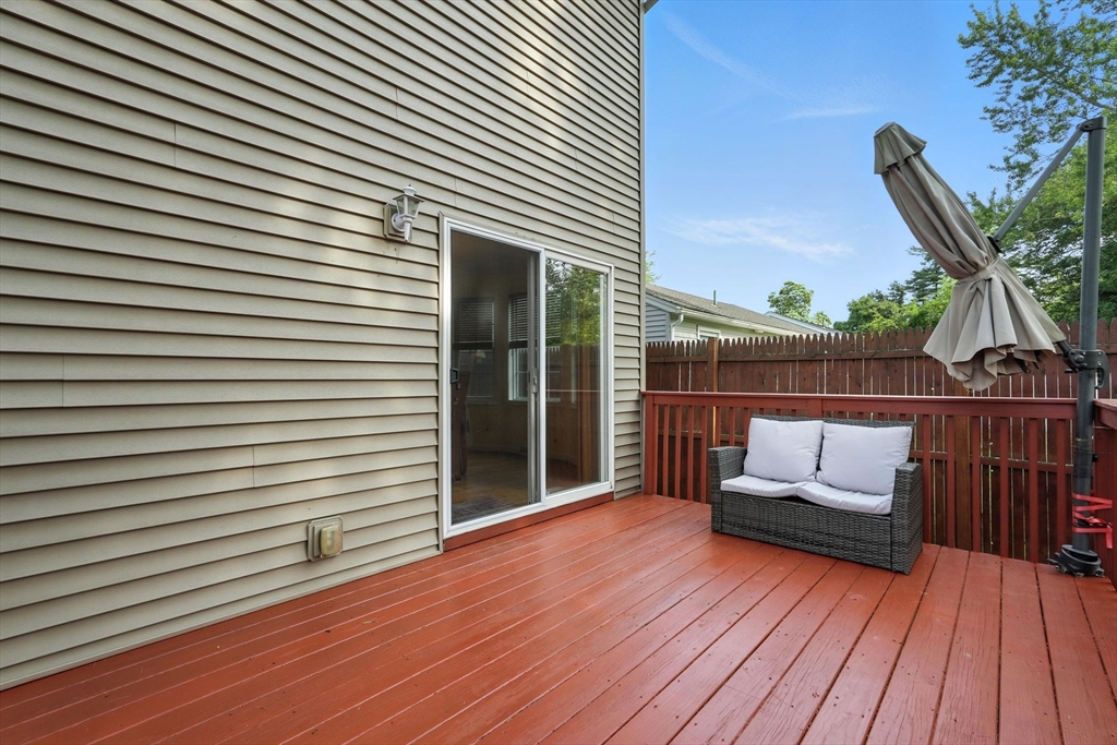 82 Lloyd Avenue Springfield, MA 01119 - Photo 28 of 32 a view of a roof deck with wooden floor and fence