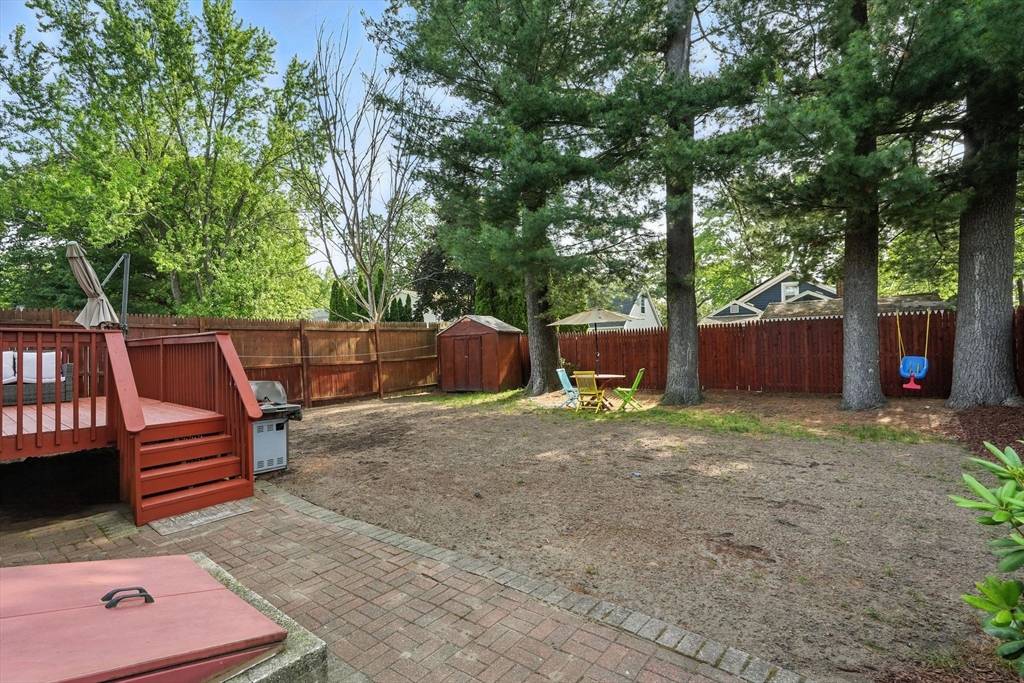 82 Lloyd Avenue Springfield, MA 01119 - Photo 32 of 32 a backyard of a house with barbeque oven and outdoor seating