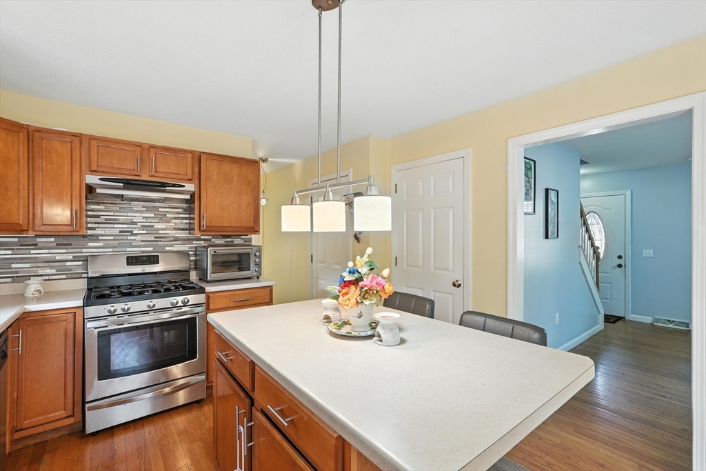 82 Lloyd Avenue Springfield, MA 01119 - Photo 10 of 32 a kitchen with a stove a sink and a refrigerator