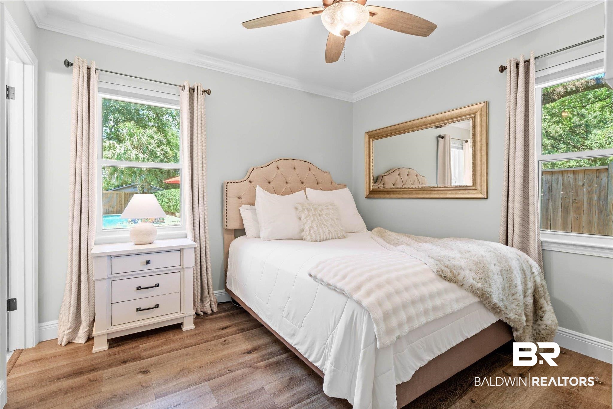 101 Ann Street Daphne, AL 36527 - Photo 15 of 38 Bright interior room featuring wood-finish flooring, light gray walls, white crown molding, and a ceiling fan with integrated lighting