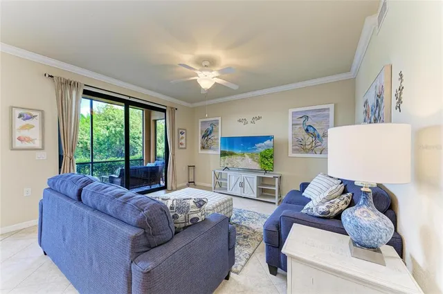 a living room with furniture a large window and a flat screen tv