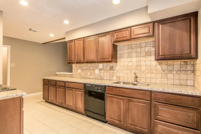 a kitchen with stainless steel appliances granite countertop a sink and cabinets
