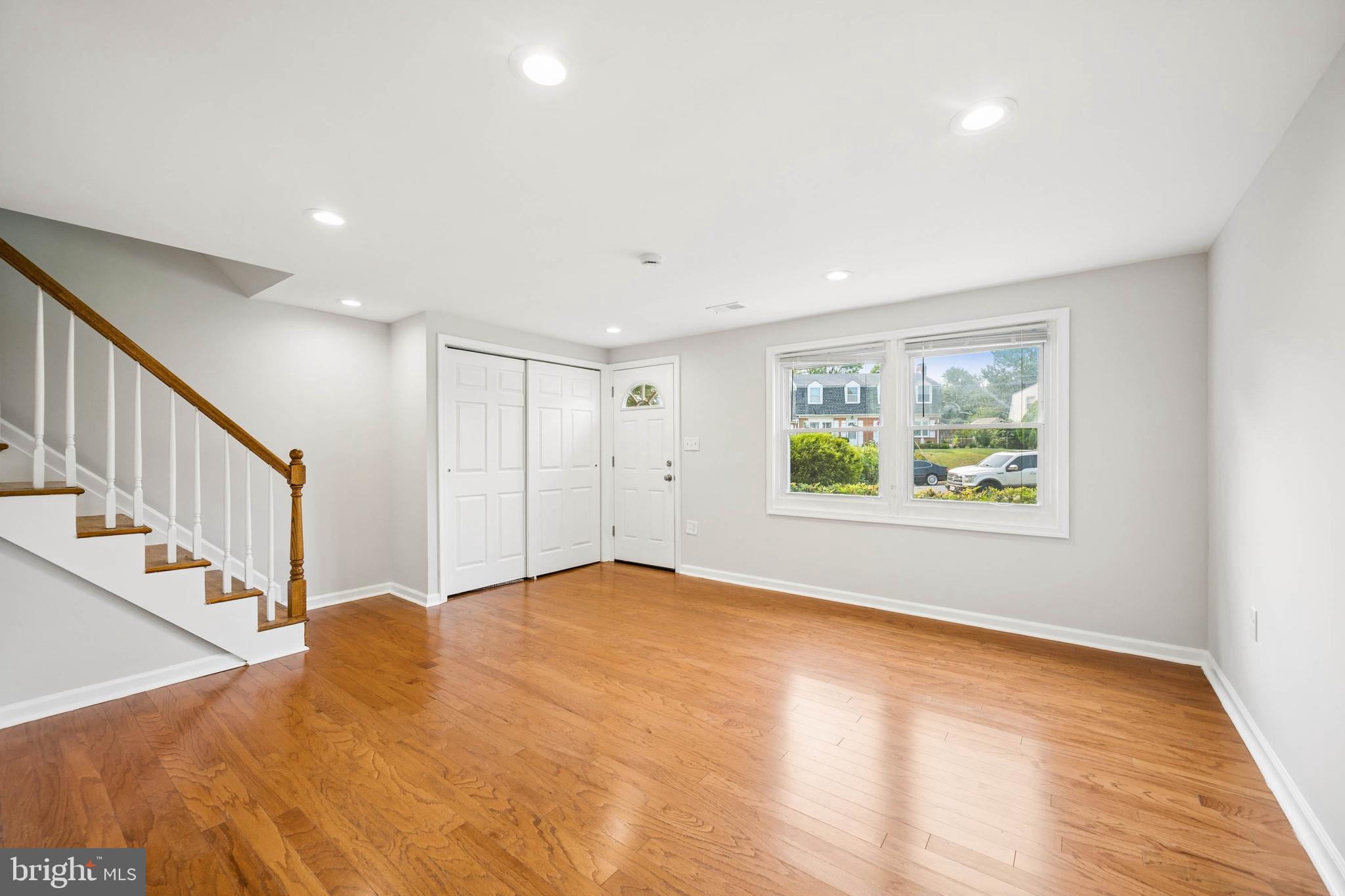 7227 Sindall Road Baltimore, MD 21234 - Photo 7 of 62 a view of an empty room with wooden floor and window