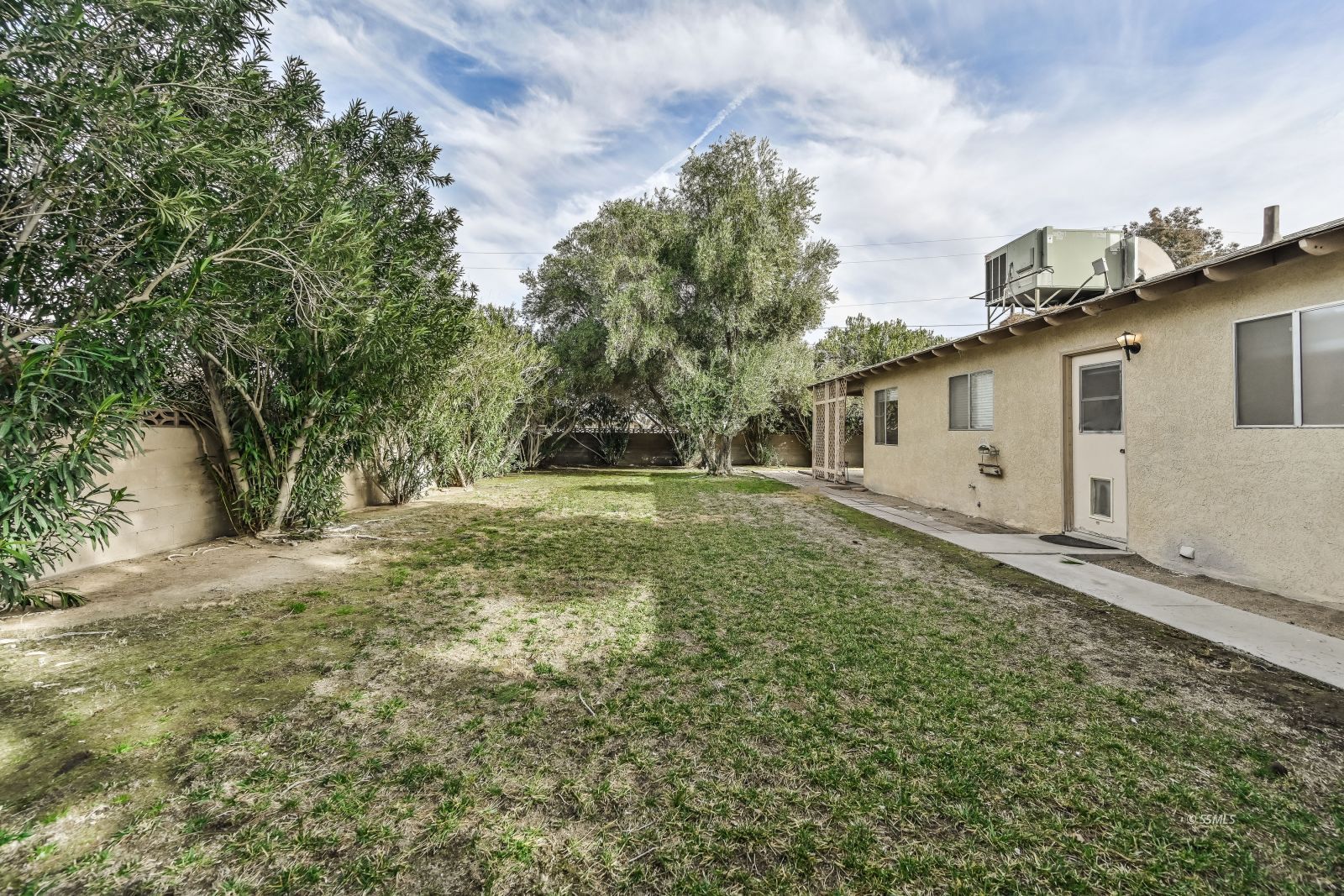 212 Rancho Street Ridgecrest, CA 93555 - Photo 23 of 25 a backyard of a house with lots of green space