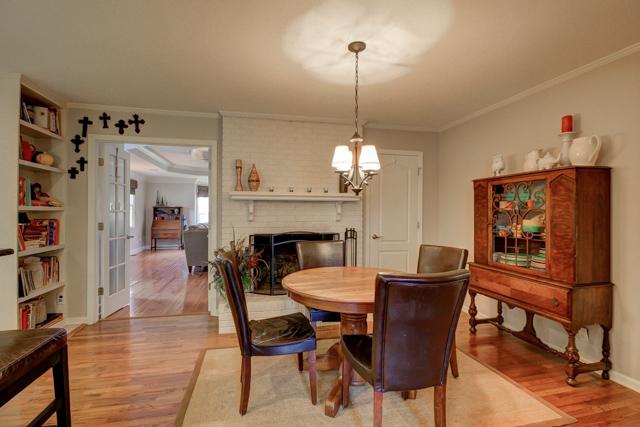 403 Sango Road Clarksville, TN 37043 - Photo 5 of 20 Breakfast area with hardwood floors, wood burning fireplace with brick hearth, and french doors leading to the living room.