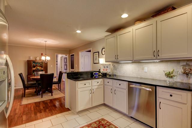 403 Sango Road Clarksville, TN 37043 - Photo 6 of 20 Right out of a magazine, with granite counters, tile back splash, tile flooring, gorgeous cabinets with new hardware, recessed lighting and updated stainless steel appliances.
