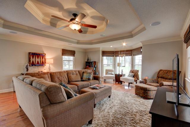 403 Sango Road Clarksville, TN 37043 - Photo 9 of 20 Large living room with hardwood floors, surround sound, and double tray ceiling with fan.