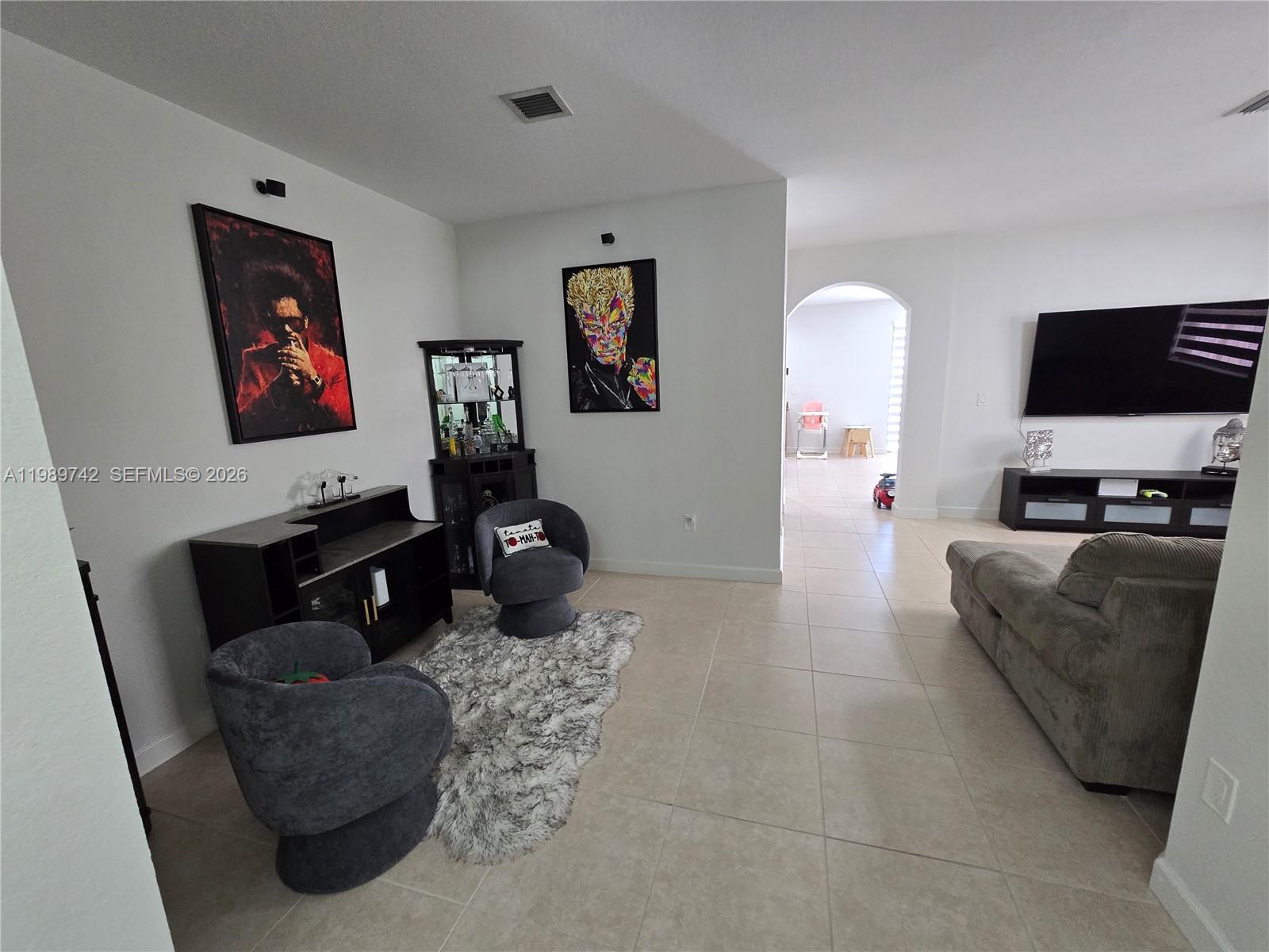24164 Southwest 113th Path Homestead, FL 33032 - Photo 16 of 68 a living room with furniture and a flat screen tv