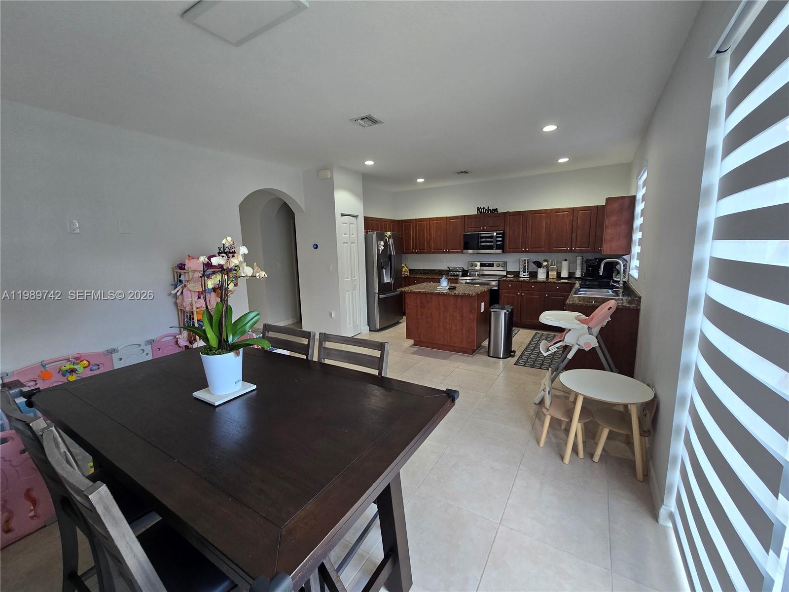 24164 Southwest 113th Path Homestead, FL 33032 - Photo 21 of 68 a dining room with furniture and wooden floor