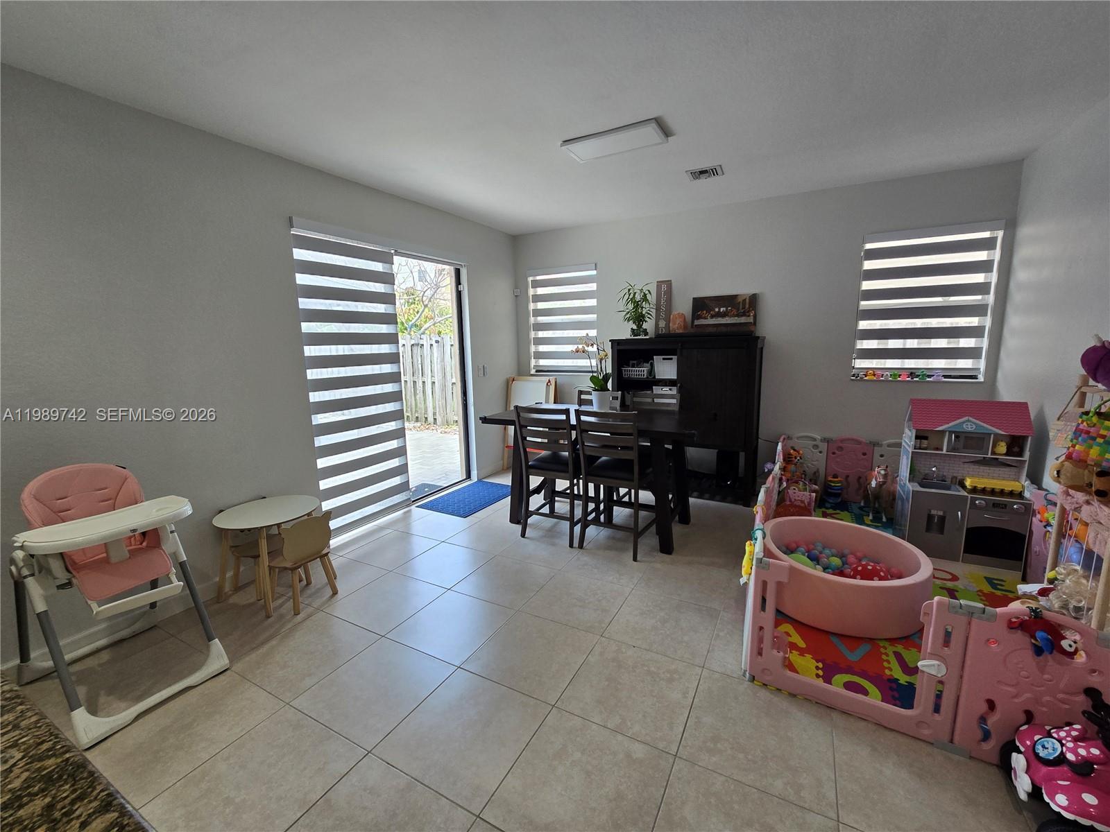 24164 Southwest 113th Path Homestead, FL 33032 - Photo 22 of 68 a room with furniture a air conditioner and a window
