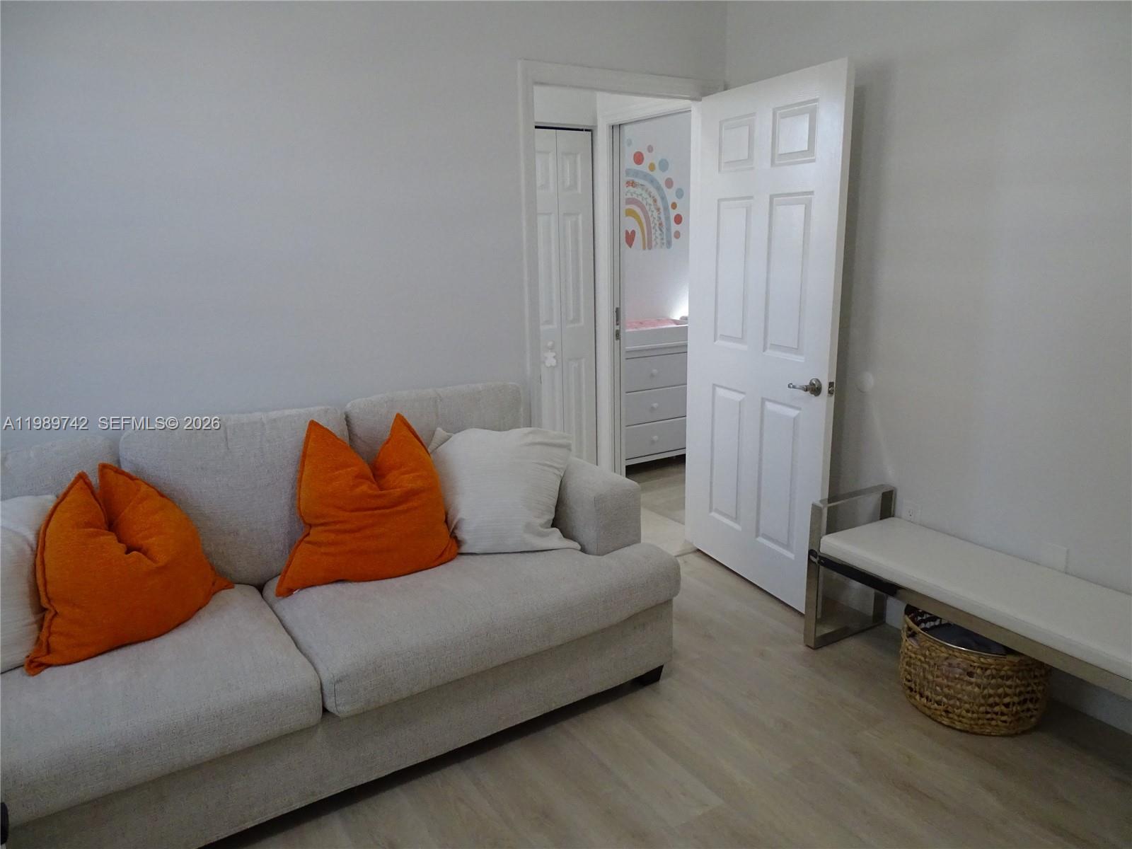 24164 Southwest 113th Path Homestead, FL 33032 - Photo 24 of 68 a living room with furniture and a wooden floor