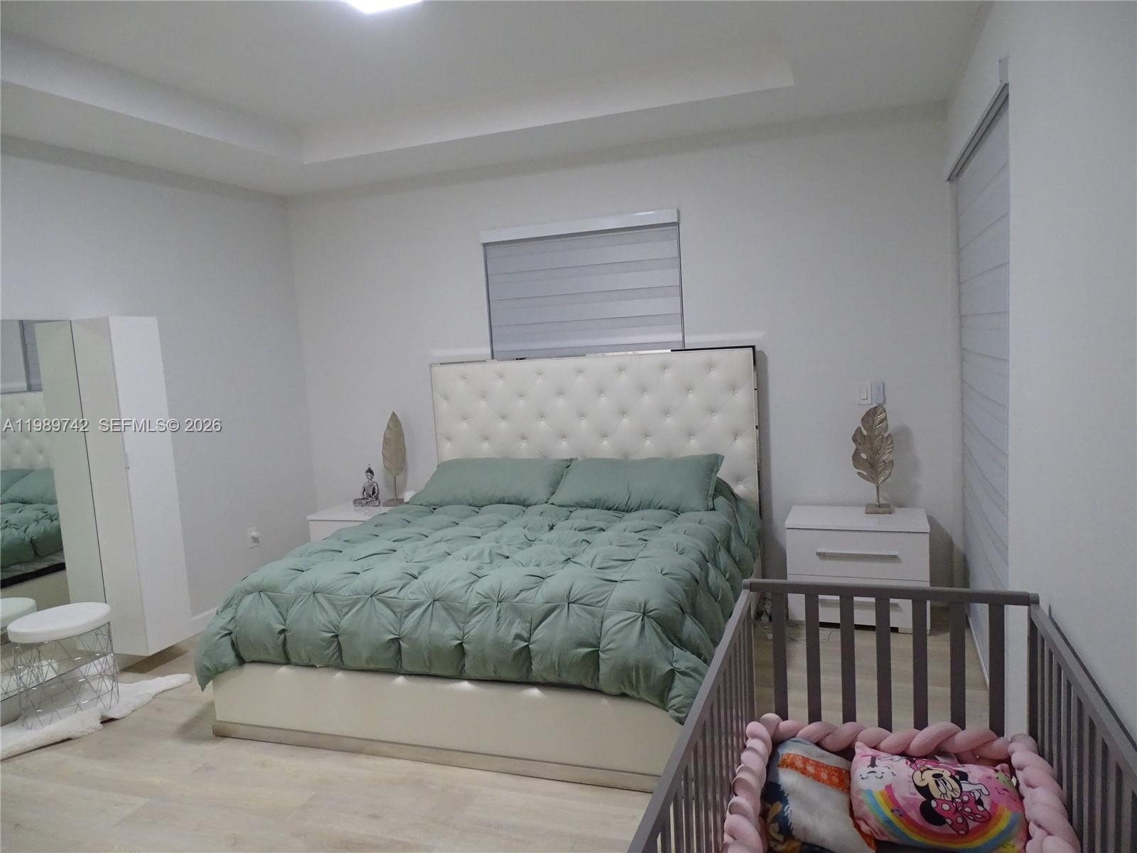 24164 Southwest 113th Path Homestead, FL 33032 - Photo 40 of 68 a bedroom with a bed and a couch