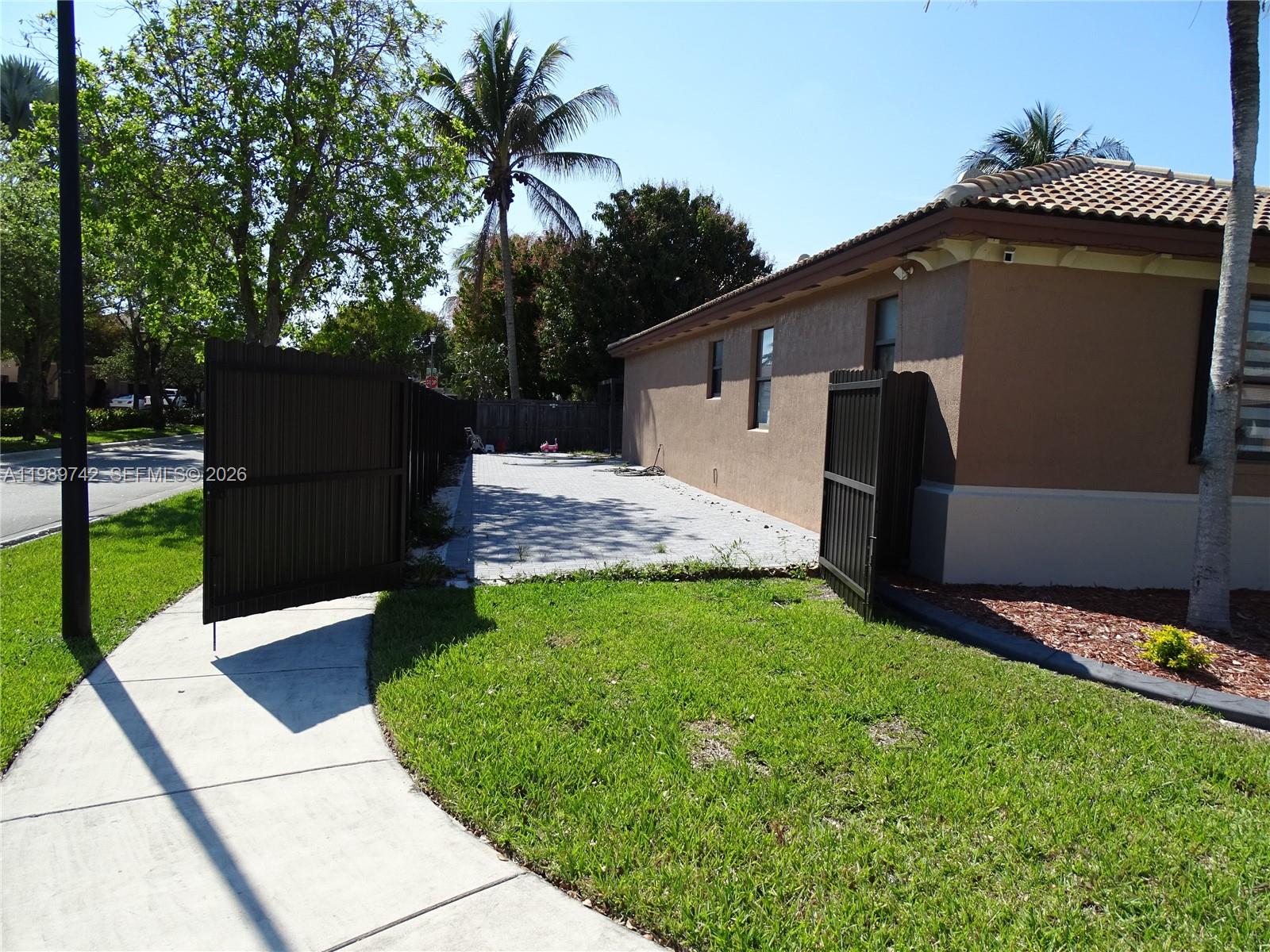 24164 Southwest 113th Path Homestead, FL 33032 - Photo 4 of 68 a front view of a house with a yard