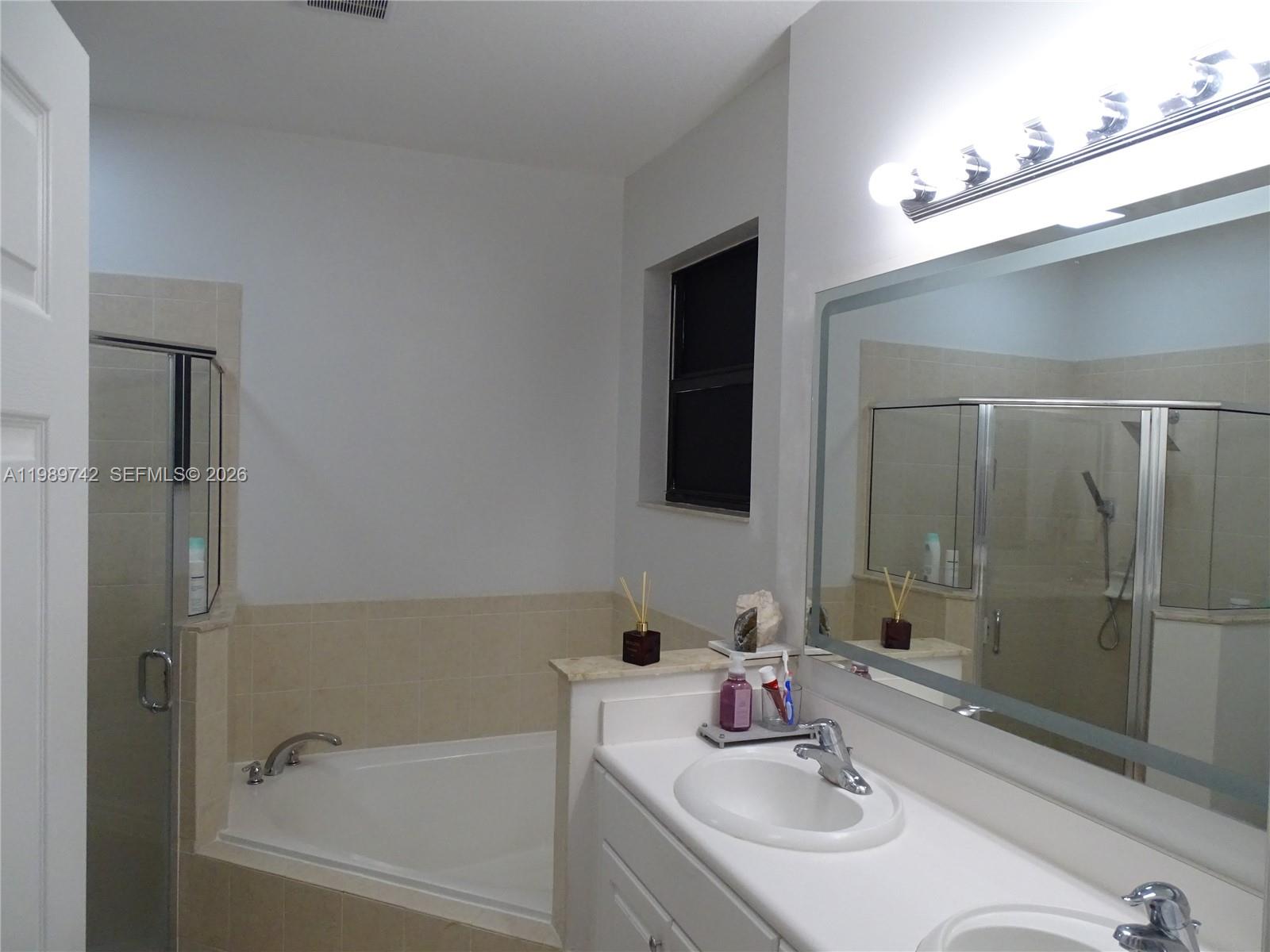 24164 Southwest 113th Path Homestead, FL 33032 - Photo 47 of 68 a bathroom with a sink and a mirror