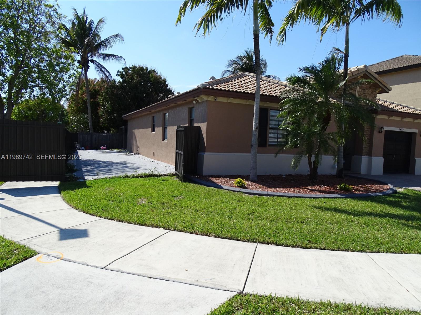 24164 Southwest 113th Path Homestead, FL 33032 - Photo 5 of 68 a front view of house with yard and green space